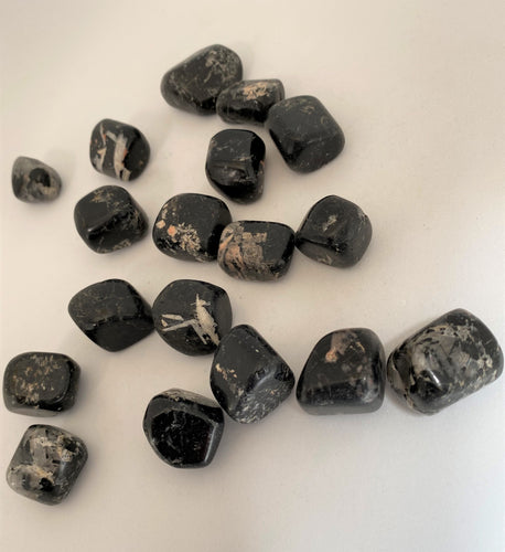 Black Tourmaline tumble stones on white background