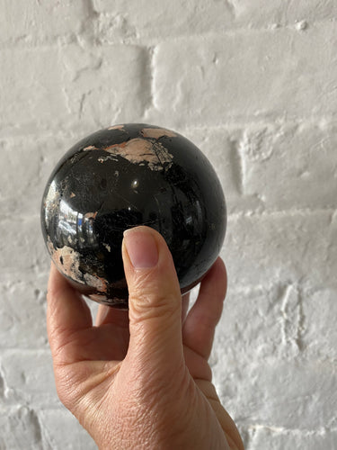 Black Onyx Crystal Sphere against white wall