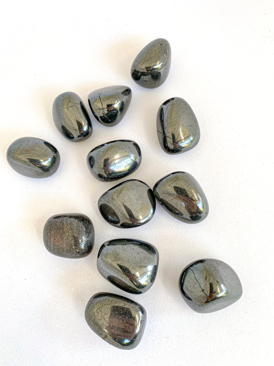 Hematite Tumble Stones on a white background