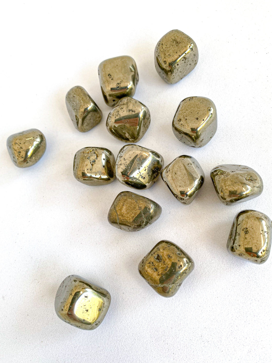 Pyrite Tumble Stones on White Background