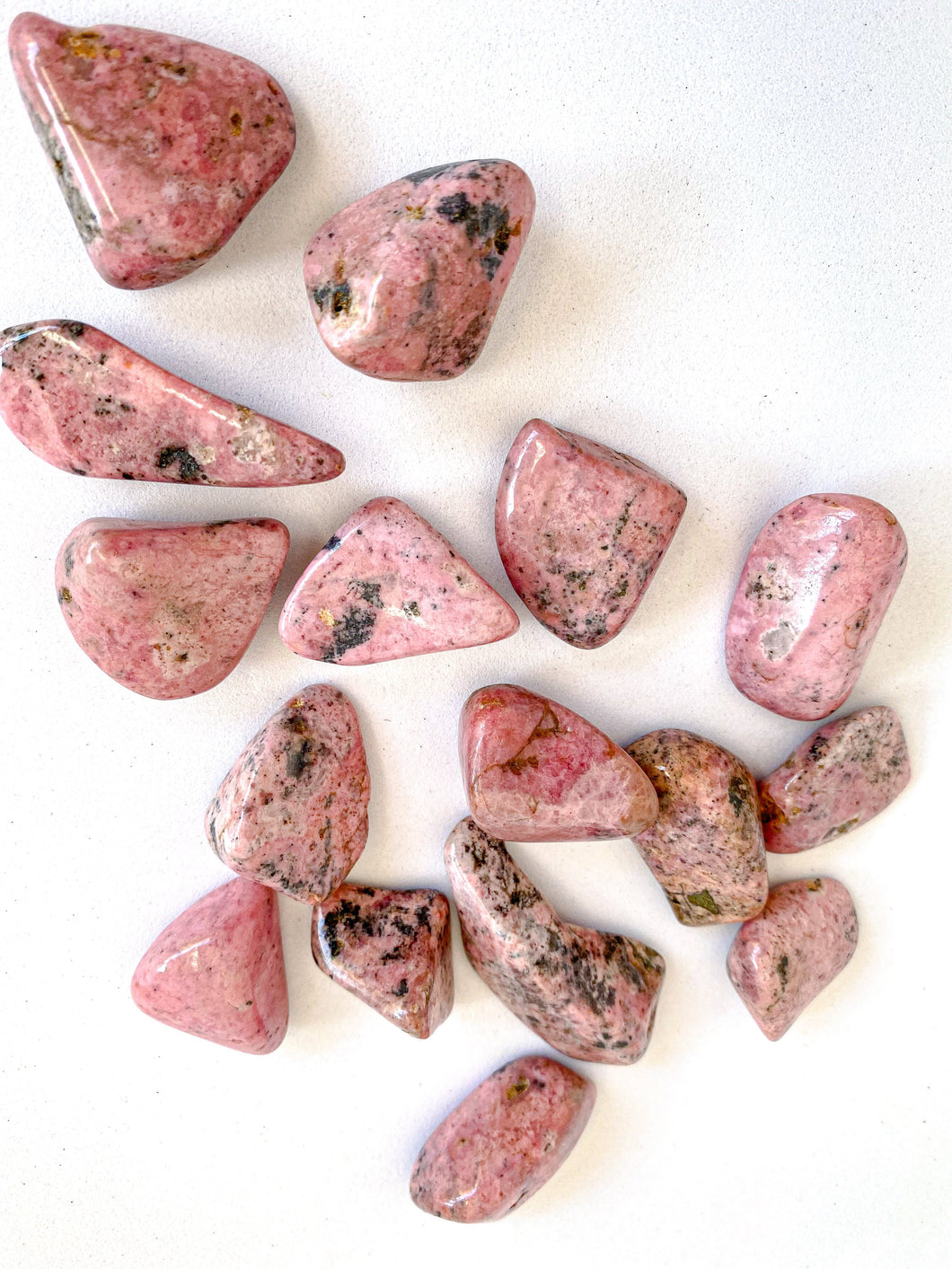 Rhodonite Tumble Stones on White Background