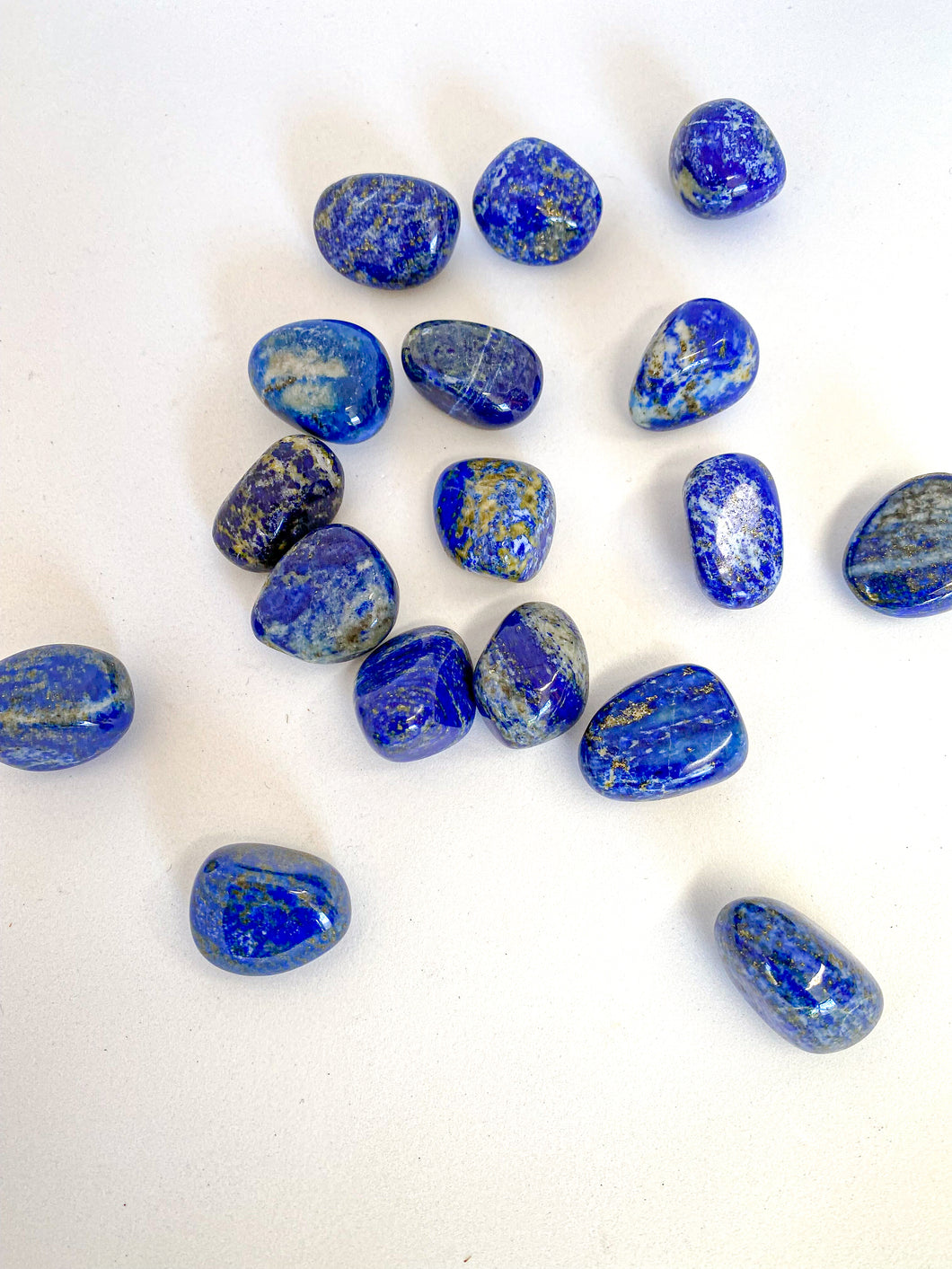 Lapis Lazuli Tumble Stones on White Background