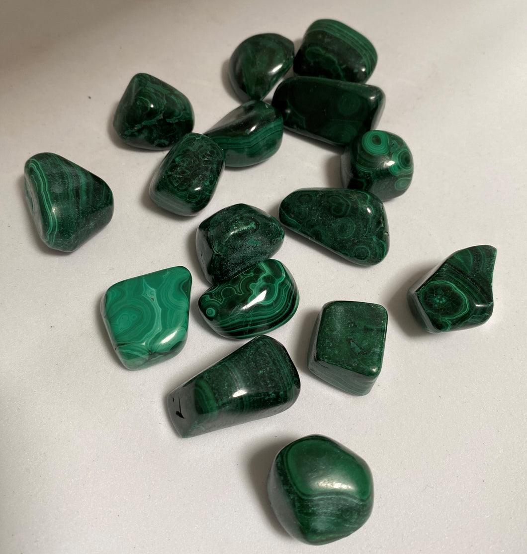 Malachite Crystal tumble stones on white background