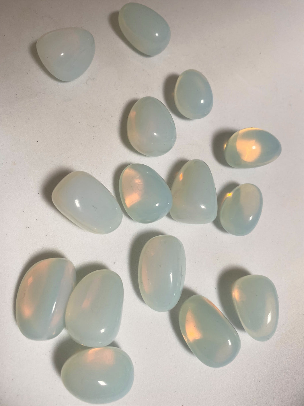 Opalite tumble stones on white background