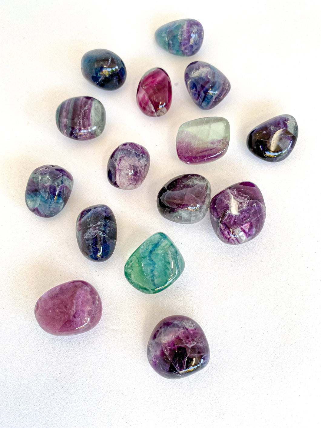 Rainbow Fluorite Tumble Stones on White Background