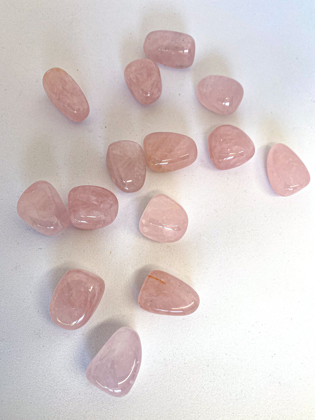 Rose Quartz Tumble Stones on White Background