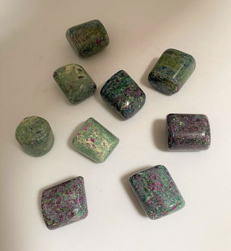 Ruby in Fuchsite tumble stones on white background